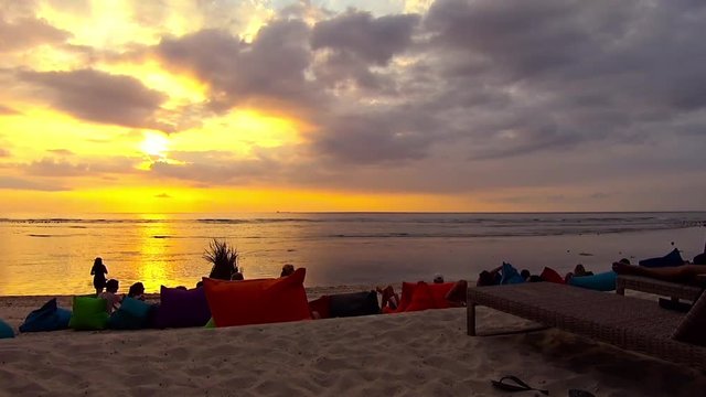Pan of the shoreline of a tipical tiny tropical island during the sunset time