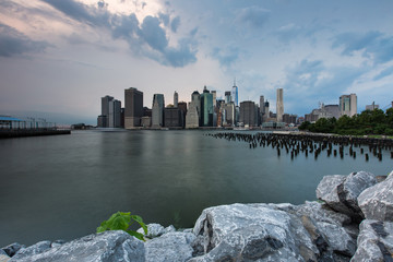 Cloudy day at Lower Manhattan Skyline view from Brooklyn Bridge Park, New York United States