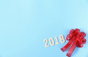 2018 text and Red bow on color background.Copy space,minimal style