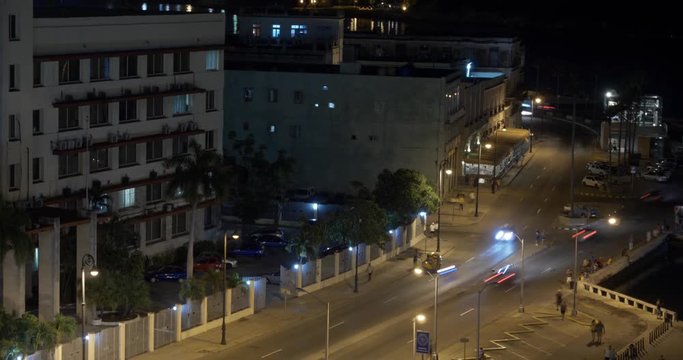 A night timelapse view of traffic in the city of Havana, Cuba and the shoreline of Havana Port Bay.  	