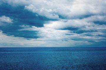 Fototapeta premium Dark clouds over the water of the sea. Summer.