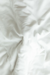 Top view of white bedding sheets after wake up in the morning