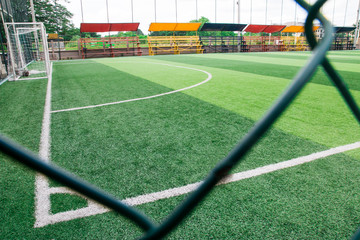 Photo of a green synthetic grass sports field with white line shot from above