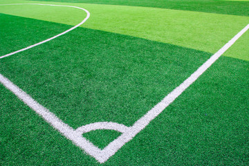 Obraz premium Photo of a green synthetic grass sports field with white line shot from above