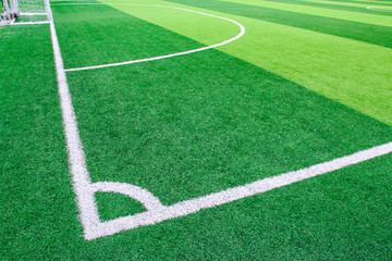 Obraz premium Photo of a green synthetic grass sports field with white line shot from above