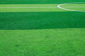 Obraz premium Photo of a green synthetic grass sports field with white line shot from above