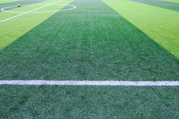 Obraz premium Photo of a green synthetic grass sports field with white line shot from above