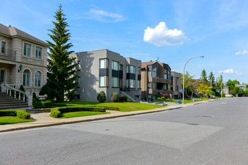 Fototapeta na wymiar Expensive modern large grey houses with huge windows in Montreal, Canada.