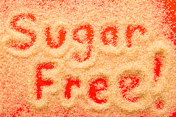 Sugar Free - hand written in raw sugar granules on red background