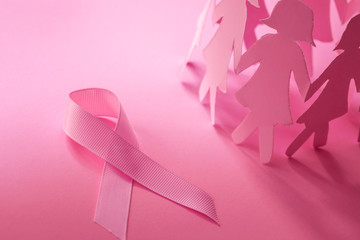 Sweet pink ribbon shape with the girl paper doll on pink background  for Breast Cancer Awareness symbol to promote  in october month campaign