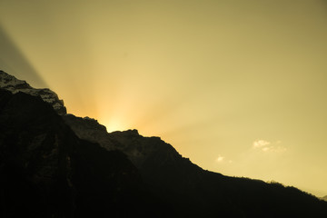 Sun beam behind mountain during morning time