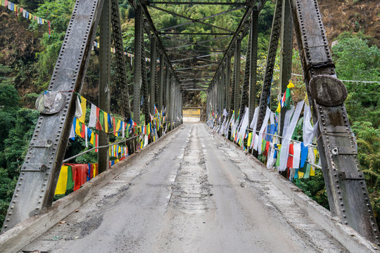 Tibetan prayer flag or Lung ta and over bridge, the flag hang on high place for wind flow wish of people all around