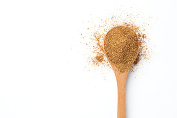 Cumin powder in wooden spoon over white background