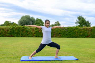 Fototapeta premium Teenage girl practising yoga outdoors