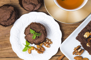 Chocolate cupcakes with mint on wooden table
