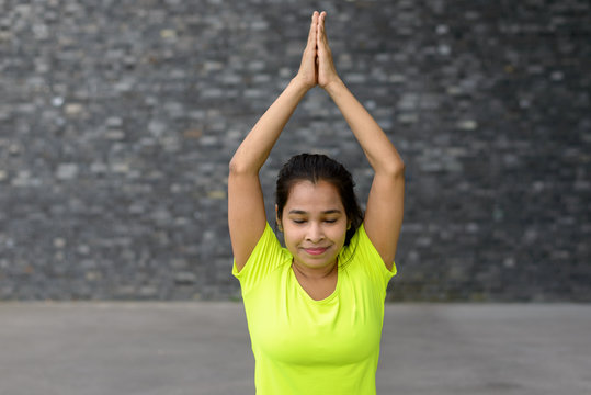 Young woman relaxing while practising yoga