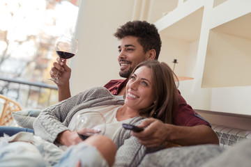 Couple drinking wine and watching television
