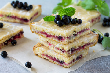 Homemade cookies with black currant berries on a gray stone or slate background. Summer pastries.
