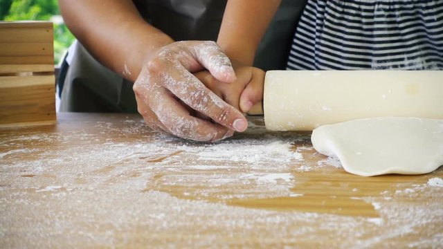 Asian mom and childhood having fun kneading dough togetherness at house