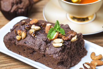 Chocolate cupcakes with mint on wooden table