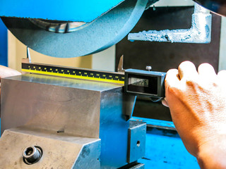 Technicians use digital counters to measure iron work from grinding. For precise quality control.