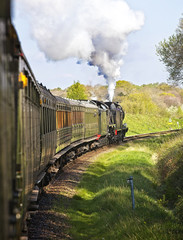 Two steam locomotives double-heading a passenger train, West Sussex, England, UK.