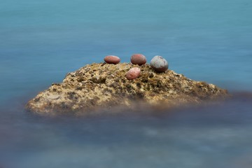 three stones on cliff