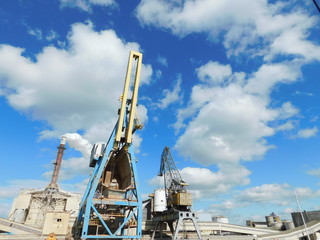 Fototapeta na wymiar Cranes and chimney in Gdansk dockyard
