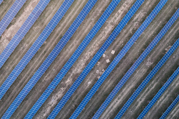 Series of solar cells located on the field in the suburbs. Aerial view. Alternative sources of energy.
