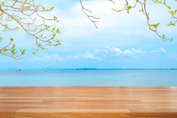Empty wooden table with blur beach on background