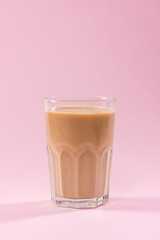 Coffee with milk on a pink background.