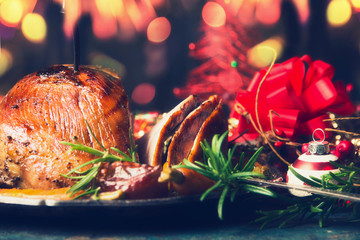 Festive Christmas table with backed ham and decoration , front view
