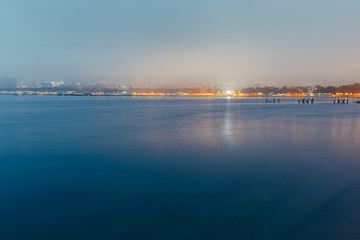 Obraz premium City By The Sea At Sunset In Fog On Background Of Harbor. Picturesque Evening Landscape. Gelendzhik, Russia