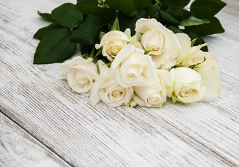 White roses on a wooden table
