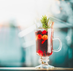 Glass of mulled wine at winter day background, front view, square