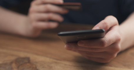 young female teen hand using smatphone to buy something