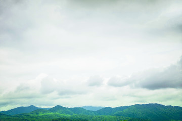 Fototapeta na wymiar sky is overcast on a rainy day over a green mountain.