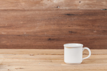 white coffee cup on wood
