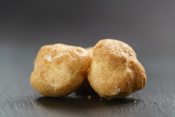 profiteroles on slate background closeup