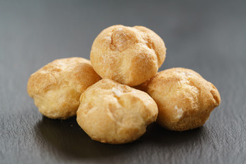 profiteroles on slate background closeup