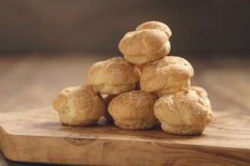 profiteroles on olive board closeup
