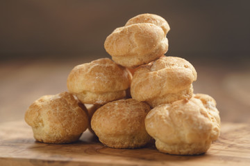 profiteroles on olive board closeup