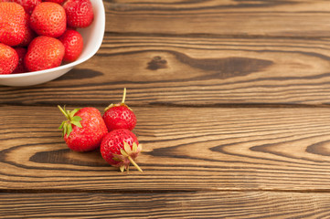 Fresh ripe strawberries on rustic background