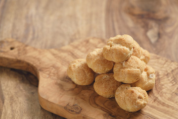 profiteroles on olive board closeup