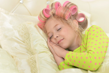 Obraz na płótnie Canvas cute little girl with hair curlers
