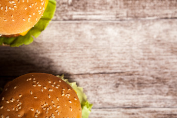 Home made burgers on wooden plate. Fast food. Unhealthy snack