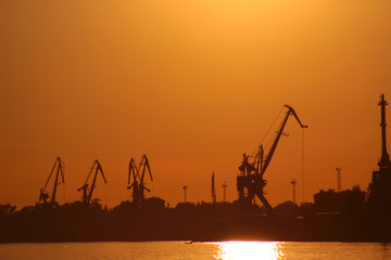 Novgorod. Volga river. cranes against a red sunset.