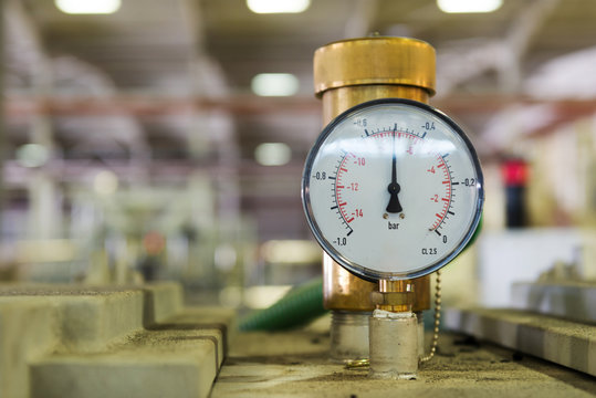 Closeup of a pressure meter on a machine