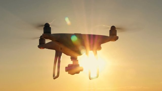 Silhouette drones.Drone flying in the sunset