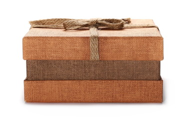 Closed golden gift box with string ribbon bow isolated on white background